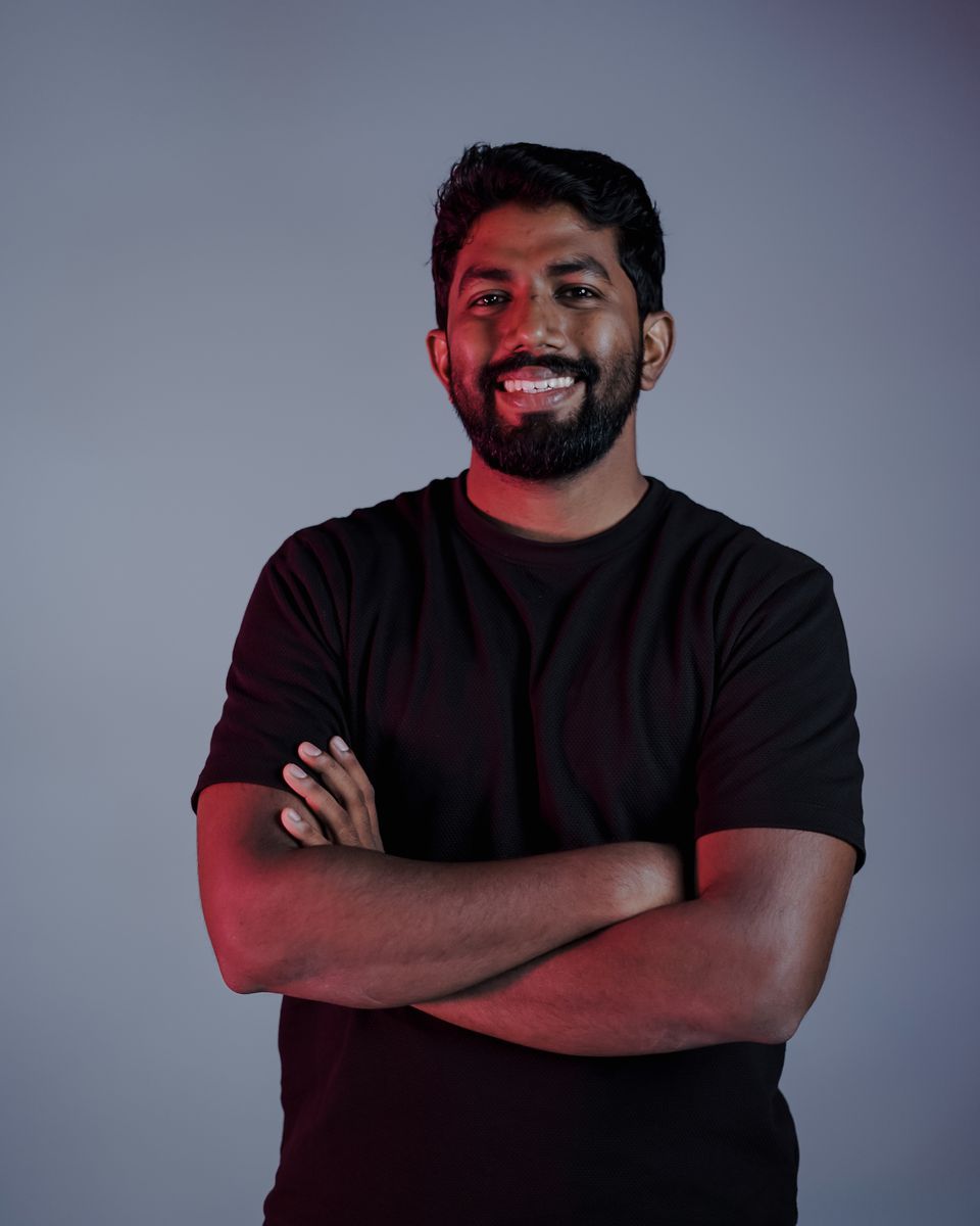 Shabeeb Nattukal, AI trainer and co-founder of Last School, smiling with arms crossed